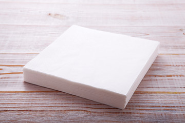 Paper napkin on wooden table close up top view mock up for design. Place for text