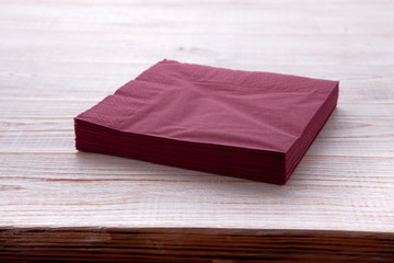 Paper napkin on wooden table close up top view mock up for design. Place for text