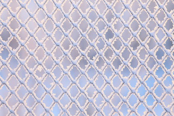 Fototapeta premium Frost on a fence in direct sunlight