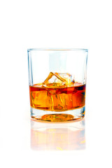 glass of whiskey with ice on a white background with reflection