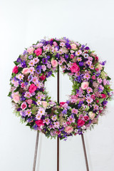 Colorful flower arrangement wreath for funerals isolated on white