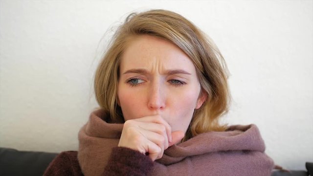 Junge europ&auml;ische Frau ist erk&auml;ltet und hustet