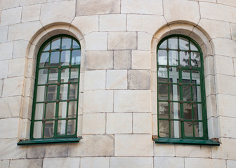 Fototapeta na wymiar Two historic green window on the yellow wall