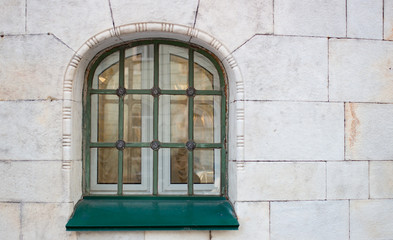 Fototapeta na wymiar Historic green window on the yellow wall