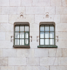 Fototapeta na wymiar Two historic green window on the yellow wall