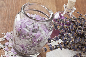 Obraz na płótnie Canvas Lavender aromatic sea salt / Aromatic sea salt, lavender dried flower, essential oil and soft towel on wooden background