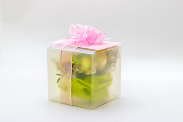 Gift and flowers on a white background