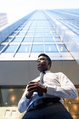 Young african businessman outside in front of the office building