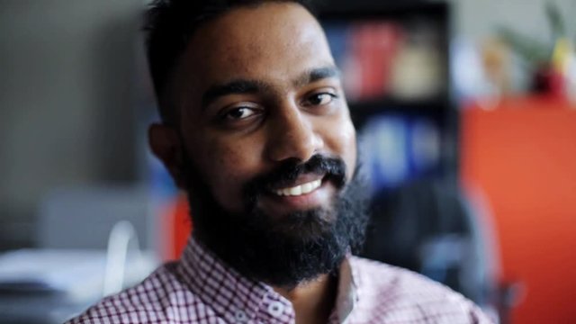 happy smiling man with beard at office