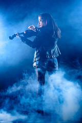Fototapeta na wymiar Rock Woman with Leather Jacket Playing a Violin