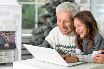 Fototapeta na wymiar Grandfather and child with laptop