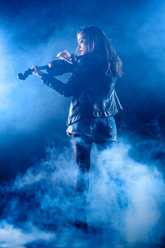 Rock Woman with Leather Jacket Playing a Violin