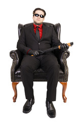 Killer sitting on chair, isolated on white background.