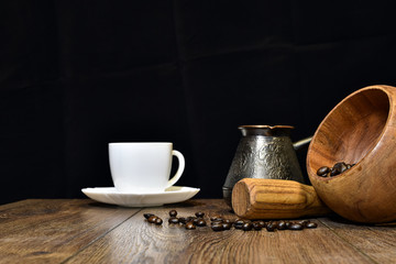 Fototapeta na wymiar Cup of coffee, beans and mortar with pestle