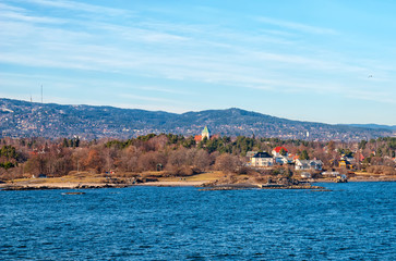 Fototapeta premium Oslo. Norway. Buildings on Peninsula Bygdoy. View from ferry boat