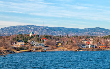 Oslo. Norway. Buildings on Peninsula Bygdoy. View from ferry boat