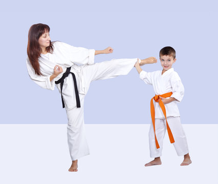 Mother and son are training kick in karategi