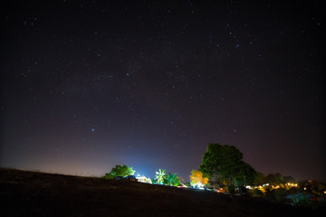 Fototapeta na wymiar Starry night over tribe village on mountain.