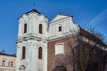 Fototapeta na wymiar The facade of the Catholic church with a belfry in Poznan.