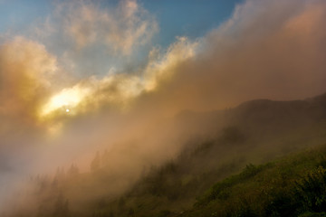 Naklejka na ściany i meble Foggy sunrise on Ceahlau mountain. Moldova. Romania