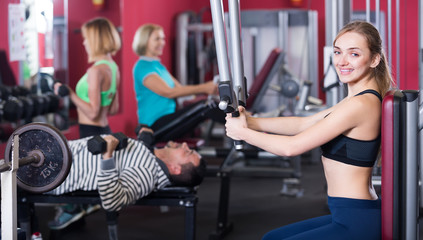 Fototapeta na wymiar Adults working out in gym.