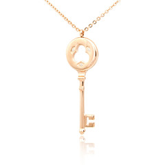 Golden diamond key pendant isolated on white