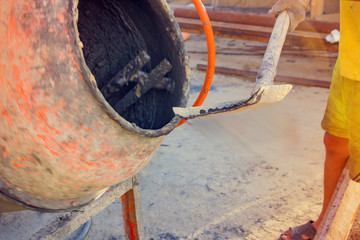 The Builder fills the cement mixer, on the construction site