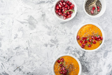 Detox and healthy breakfast with seasonal fruits, milk, chia seeds, pomegranate   herbs on a gray marble background. Top view. The concept of  organic natural food.