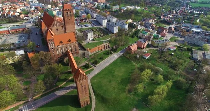 Aerial 4K Nice panoramic view of Medieval Teutonic Knight's brick castle and St. John the Evangelist Cathedral in Kwidzyn, with town surroundings 