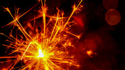 Christmas and New Year party sparkler with abstract circular bokeh background Christmas lights.