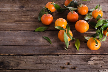 Mandarins Tangerines on wooden background. Free space for your text.