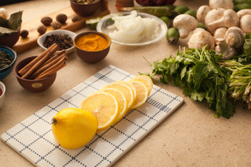 Sliced lemon on the table, prepared for cooking meal. Healthy lifestyle which including vitamins from vegetables.