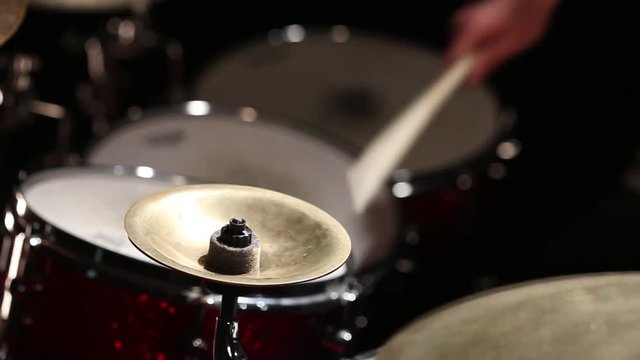 Drummer playing in the studio. Black background