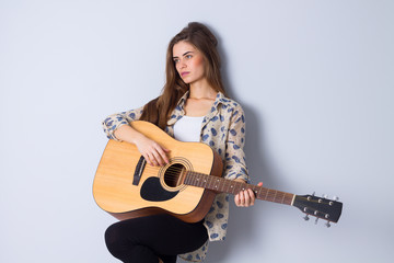 Fototapeta premium Young woman holding a guitar 