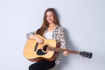 Fototapeta premium Young woman holding a guitar 