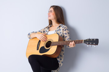Fototapeta premium Young woman holding a guitar 