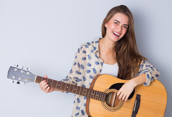 Young woman holding a guitar 