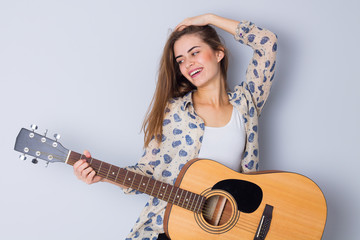 Fototapeta premium Young woman holding a guitar 