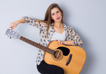 Fototapeta premium Young woman holding a guitar 