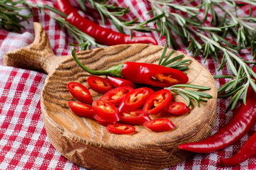 Spicy chili peppers on wooden kitchen Board