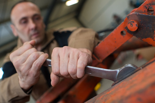 mechanic man using a wrench