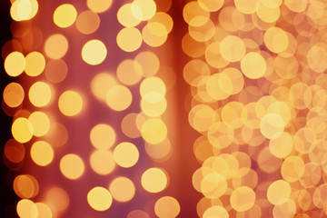 Christmas shiny bokeh in yellow golden colors, new year illunination. Seasonal vintage hipster holiday background.