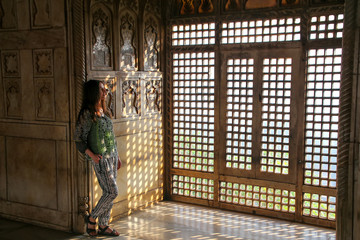 Young woman standing by the window in Khas Mahal, Agra Fort, Utt