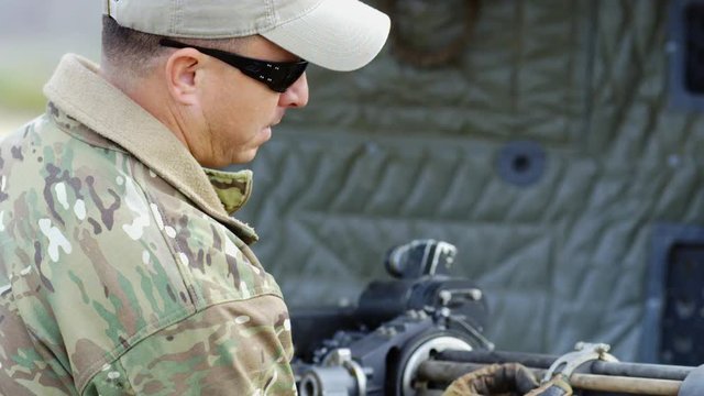 A military man prepares the Dillon Minigun