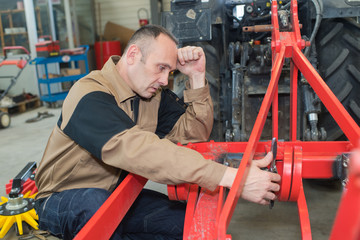 Agricultural mechanic looking stressed