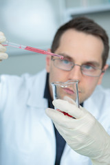 science professional pipetting solution into the glass cuvette