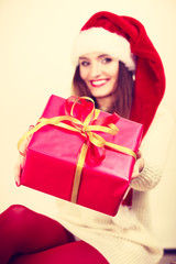 Woman holding gift box. Christmas time