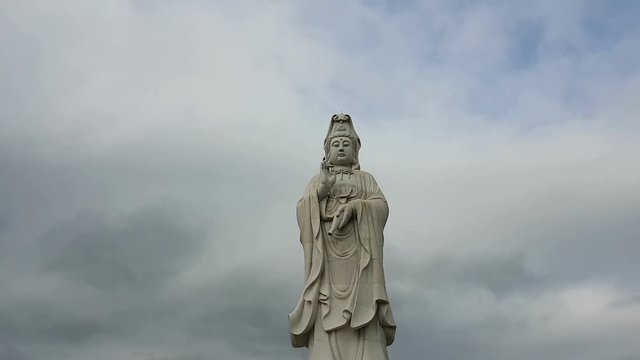 time lapse White marble Quan Yin stand near The Bridge of the River Kwai