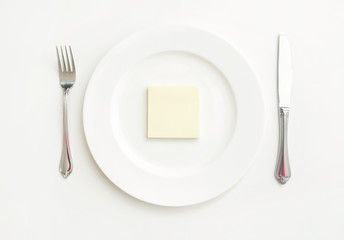 Yellow piece of paper on plate on table
