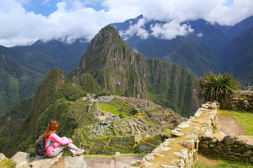 Woman enjoying the view of Machu Picchu citadel in Peru